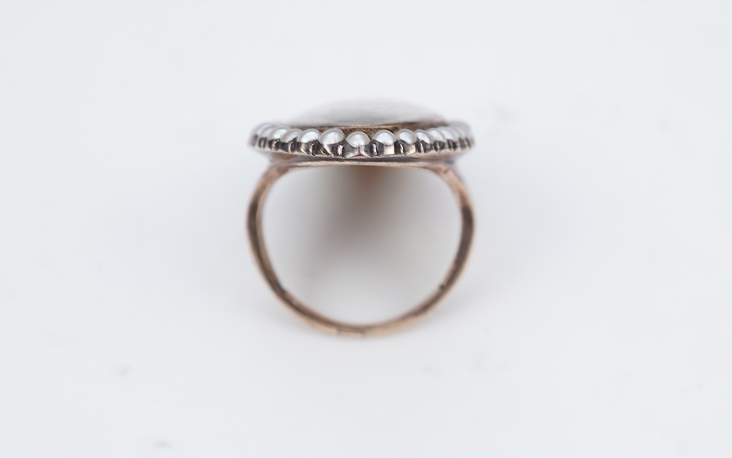 A fine George III seed pearl, enamel and diamond mourning ring, circa 1782